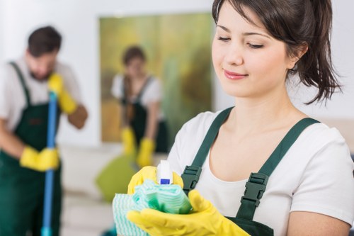 Cleaner mopping a shared entrance floor in a Kingston property